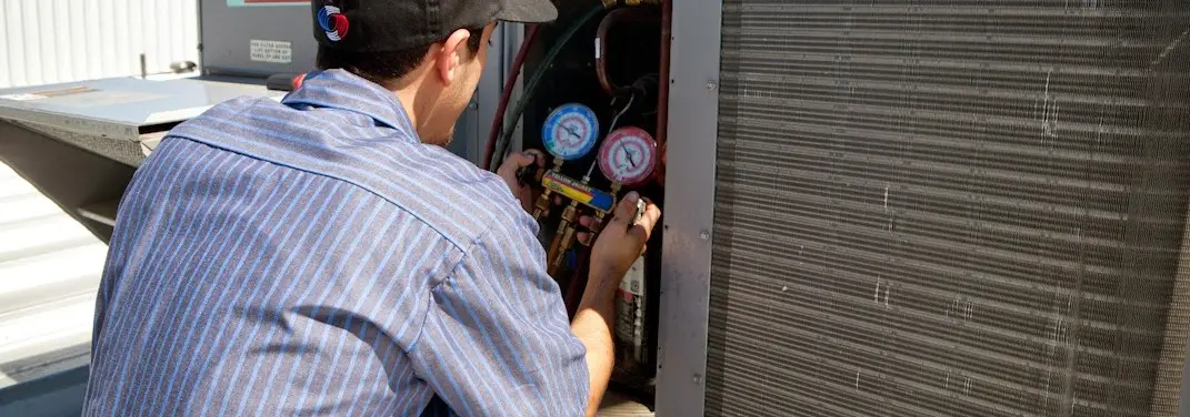 HVAC technician servicing a condenser unit in Citrus