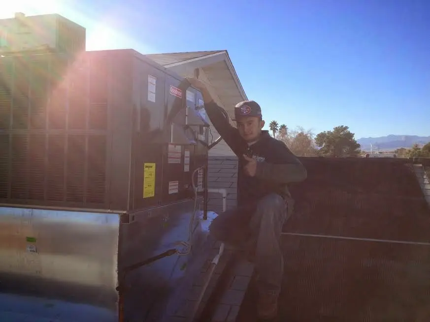 HVAC technician performing Boiler Repair on a rooftop unit in Citrus